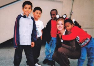 a teacher wearing a deer costume with her students