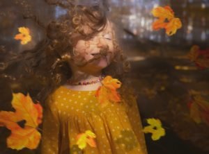 girl in the wind with autumn leaves...